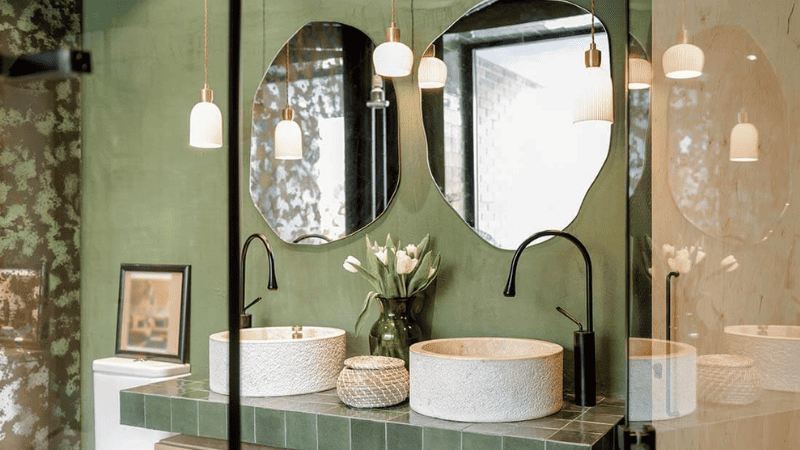 Pendant lights offer a stylish alternative to traditional wall sconces for illuminating your vanity area