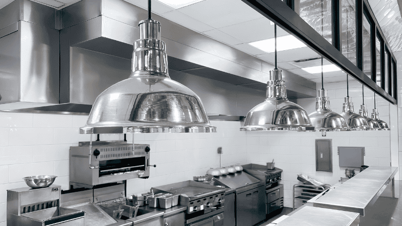 The hotel kitchen features chandeliers and cold white light