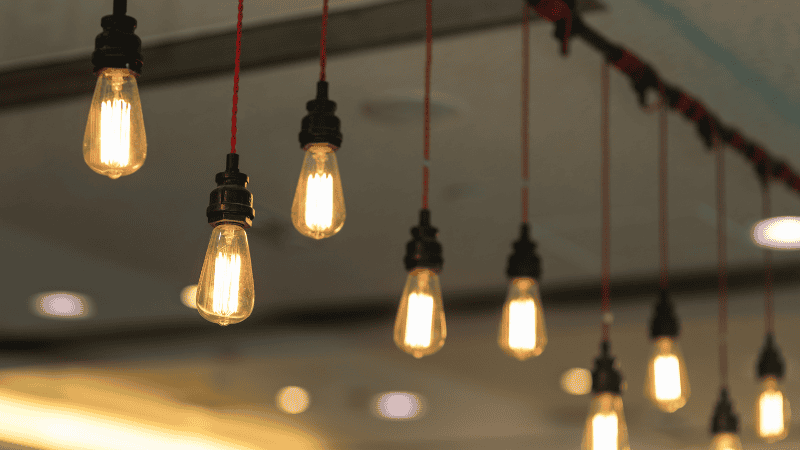 An enclosed fixture hanging from ceiling in a room. 