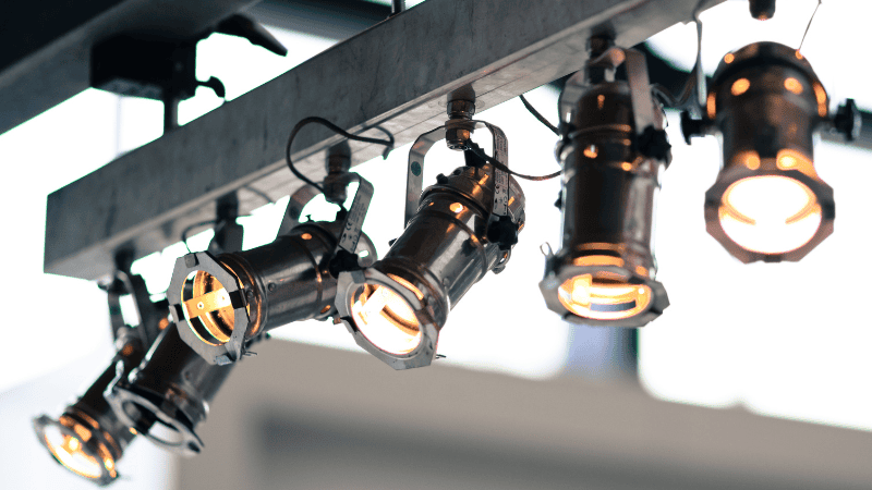 Stage lights hanging from iron shelves