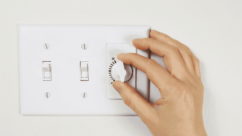A woman is setting the automatic lighting timer.