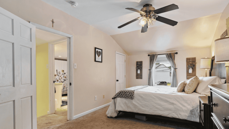 The modern-style bedroom is paired with warm lights and ceiling fans