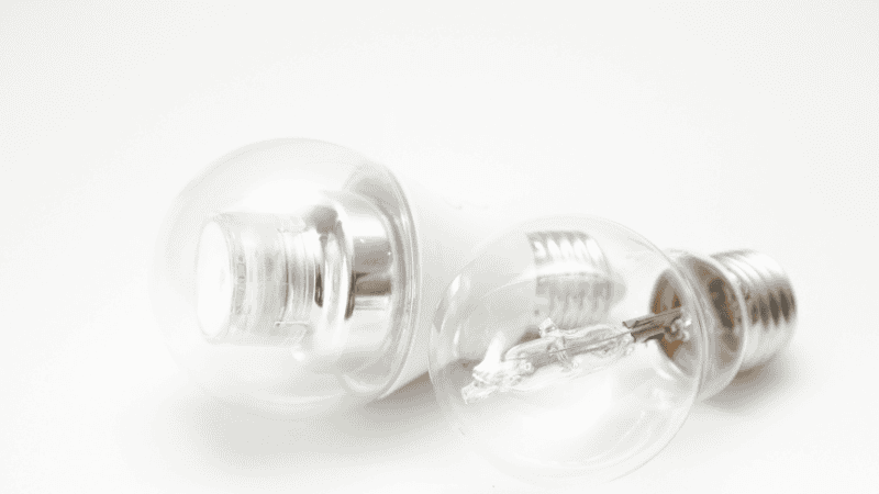 Two LED bulbs made of filaments of different shapes and materials are on display.
